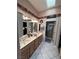 Bathroom with double sinks, light wood cabinets, and tile flooring at 2925 Big Green Ln, Las Vegas, NV 89134