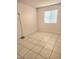 Bedroom featuring tile flooring and window with blinds at 4480 Annie Oakley Dr, Las Vegas, NV 89121