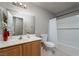 Clean bathroom with wood vanity, toilet, and bathtub shower at 4772 Double Down Dr # 102, Las Vegas, NV 89122