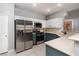 Modern kitchen with stainless steel appliances and teal cabinets at 4772 Double Down Dr # 102, Las Vegas, NV 89122