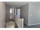 Upstairs hallway with white railing and grey carpet at 8350 Sterling Harbor Ct, Las Vegas, NV 89117