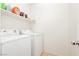 Laundry room with washer, dryer, and overhead shelving at 9116 Ironstone Ave, Las Vegas, NV 89143