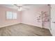 Charming bedroom with wood-look floors, ceiling fan, and pink walls at 10146 Robins Hollow Rd, Las Vegas, NV 89183