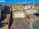 Two-story house with beige exterior, two-car garage, and landscaped yard at 10280 Fragrant Apple Ct, Las Vegas, NV 89141