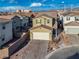 Two-story house with beige exterior, two-car garage, and landscaped yard at 10280 Fragrant Apple Ct, Las Vegas, NV 89141