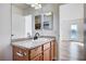 Bathroom with granite vanity, double sinks, and access to bedroom at 10324 Midseason Mist St, Las Vegas, NV 89183