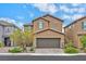 Two story house with brown exterior, stone accents, and a two car garage at 139 Fulgora St, Henderson, NV 89074