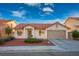 Single-story house with terracotta roof, landscaped front yard, and attached garage at 1555 Bent Arrow Dr, North Las Vegas, NV 89031