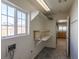 Bright laundry room with built-in shelving and window at 2440 Robison Farm Rd, Logandale, NV 89021