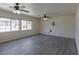 Living area with grey vinyl flooring and large windows at 2440 Robison Farm Rd, Logandale, NV 89021