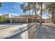 Three-car garage, mature trees, and a large front yard at 2836 S Tioga Way, Las Vegas, NV 89117