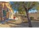 Landscaped backyard with gravel, trees, and a fenced perimeter at 3713 Corte Bella Hills Ave, North Las Vegas, NV 89081