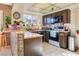 Kitchen with wood cabinets, tile floor, and a breakfast bar at 3778 Spitze Dr, Las Vegas, NV 89103