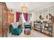 Living room featuring comfy armchairs, bookshelves, and a festive Christmas tree at 3778 Spitze Dr, Las Vegas, NV 89103