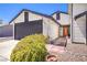 Front view of a single-story home with an orange front door at 3875 Sebasco Dr, Las Vegas, NV 89147