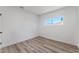 Simple bedroom with wood-look floors and a window at 3976 Belleville Ave, Las Vegas, NV 89121