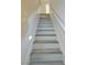 Modern staircase with light gray wood-look flooring at 4384 Silver Bay St, Las Vegas, NV 89147