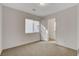 Bright bedroom with neutral walls and carpet flooring. Features a window and a door to a closet at 6007 Whitmire Ave, Las Vegas, NV 89139