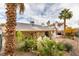 Landscaped backyard with covered patio and fire pit area at 6105 Heather Mist Ln, Las Vegas, NV 89108