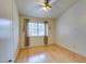 Bright bedroom with light wood flooring and ceiling fan at 6105 Heather Mist Ln, Las Vegas, NV 89108