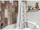 Bathroom with shower/tub combo and wood-look tile at 6333 Lorille Ln, Las Vegas, NV 89108