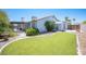 Landscaped backyard with a curved lawn and storage shed at 6408 Fisher Ave, Las Vegas, NV 89130