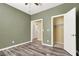 Bedroom with ceiling fan, neutral walls, and wood flooring at 6491 Bristle Canyon Ave, Las Vegas, NV 89110