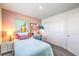 Bedroom with teal bedding and pink accent wall at 6570 Coffee Theme St # Lot 5, North Las Vegas, NV 89084