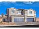 Two-story townhome with gray siding, two-car garage, and landscaping at 6570 Coffee Theme St # Lot 5, North Las Vegas, NV 89084