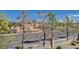 View of residential street with mature trees at 7700 Constanso Ave # 203, Las Vegas, NV 89128