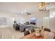 Bright living room featuring a modern fireplace and large TV at 10008 Hope Island Dr, Las Vegas, NV 89134