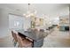 Bright dining area with a large wooden table and leather chairs, looking into the kitchen at 10981 Laureldale Ct, Las Vegas, NV 89141