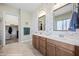 Double vanity bathroom with decorative wallpaper and ample storage at 1143 Tortoise Mountain Dr, Mesquite, NV 89034