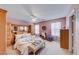 Spacious main bedroom with a large bed, built-in dresser, and ceiling fan at 174 Sandhill Crane Ave, Henderson, NV 89002