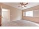 Well-lit bedroom featuring carpet and a ceiling fan at 2053 Quarry Ridge St # 106, Las Vegas, NV 89117