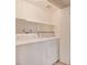 Bright laundry room with Whirlpool washer and dryer, and shelving at 2053 Quarry Ridge St # 106, Las Vegas, NV 89117