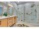 Modern bathroom with large walk-in shower and marble tile at 2168 Tiger Willow Dr, Henderson, NV 89012