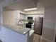 Modern kitchen with stainless steel appliances and white cabinets at 2300 E Silverado Ranch Blvd # 1072, Las Vegas, NV 89183