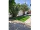 Landscaped backyard with artificial turf, fire pit, and palm trees at 3123 Congress Ave, Las Vegas, NV 89121