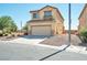 Two-story house with attached garage, desert landscaping, and a paved driveway at 3548 Lonesome Drum St, North Las Vegas, NV 89032