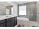 Modern bathroom with soaking tub, walk-in shower, and gray hexagon tile at 647 Quarry Pass, Mesquite, NV 89034