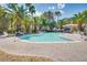 Community pool with surrounding patio furniture and palm trees at 6480 Annie Oakley Dr # 314, Las Vegas, NV 89120