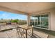 Covered patio with dining area and sliding glass doors leading to the backyard at 699 Glowing Horizon St, Henderson, NV 89052