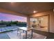 Relaxing backyard patio with seating area and view of sunset at 699 Glowing Horizon St, Henderson, NV 89052