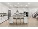 Modern kitchen with white cabinets, stainless steel appliances and breakfast bar at 699 Glowing Horizon St, Henderson, NV 89052