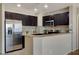 Stainless steel appliances and dark wood cabinets in this kitchen at 8255 Las Vegas Blvd # 1317, Las Vegas, NV 89123