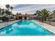 Community pool with palm trees and seating at 929 Willow Tree Dr # B, Las Vegas, NV 89128