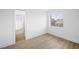 Well-lit bedroom with wood-look floors and access to a hallway at 9795 La Cienega St, Las Vegas, NV 89183