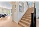 Modern staircase with light hardwood treads and black metal railing at 10002 Trapper Mountain St, Las Vegas, NV 89178