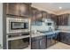 Modern kitchen with stainless steel appliances and granite countertops at 10417 Bent River St, Las Vegas, NV 89183